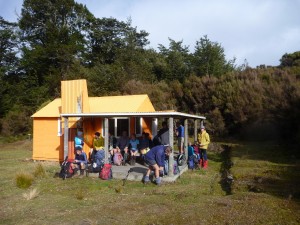The verandah, bursting with trampers at Middle Hill
