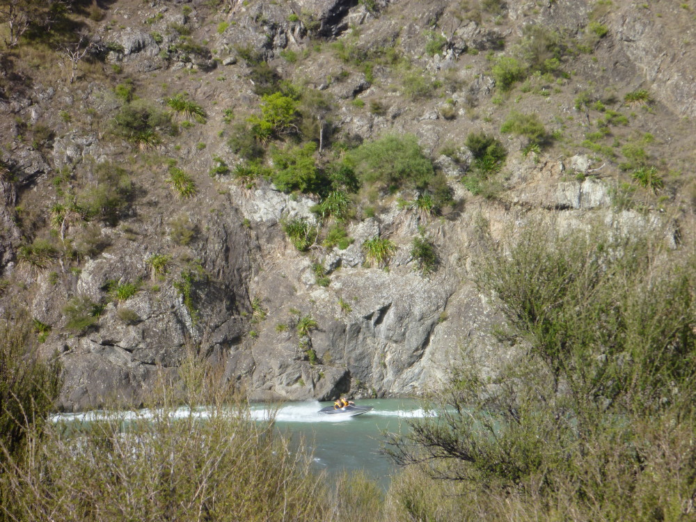 One of the five speed boats coming up river